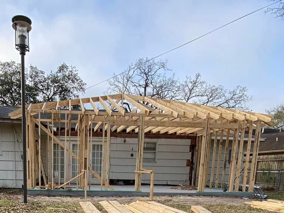 Rear room addition framed against the back of an existing house
