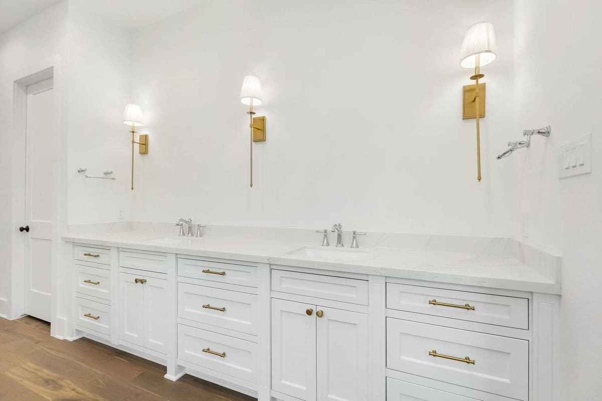 Double vanity with quartz top, brass hardware and sconces