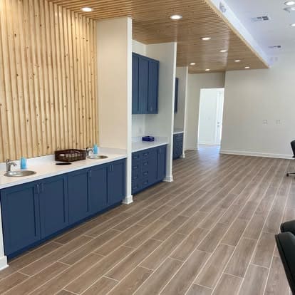 Commercial interior with navy built-in cabinetry, a wood slat wall and wood-look tile floors