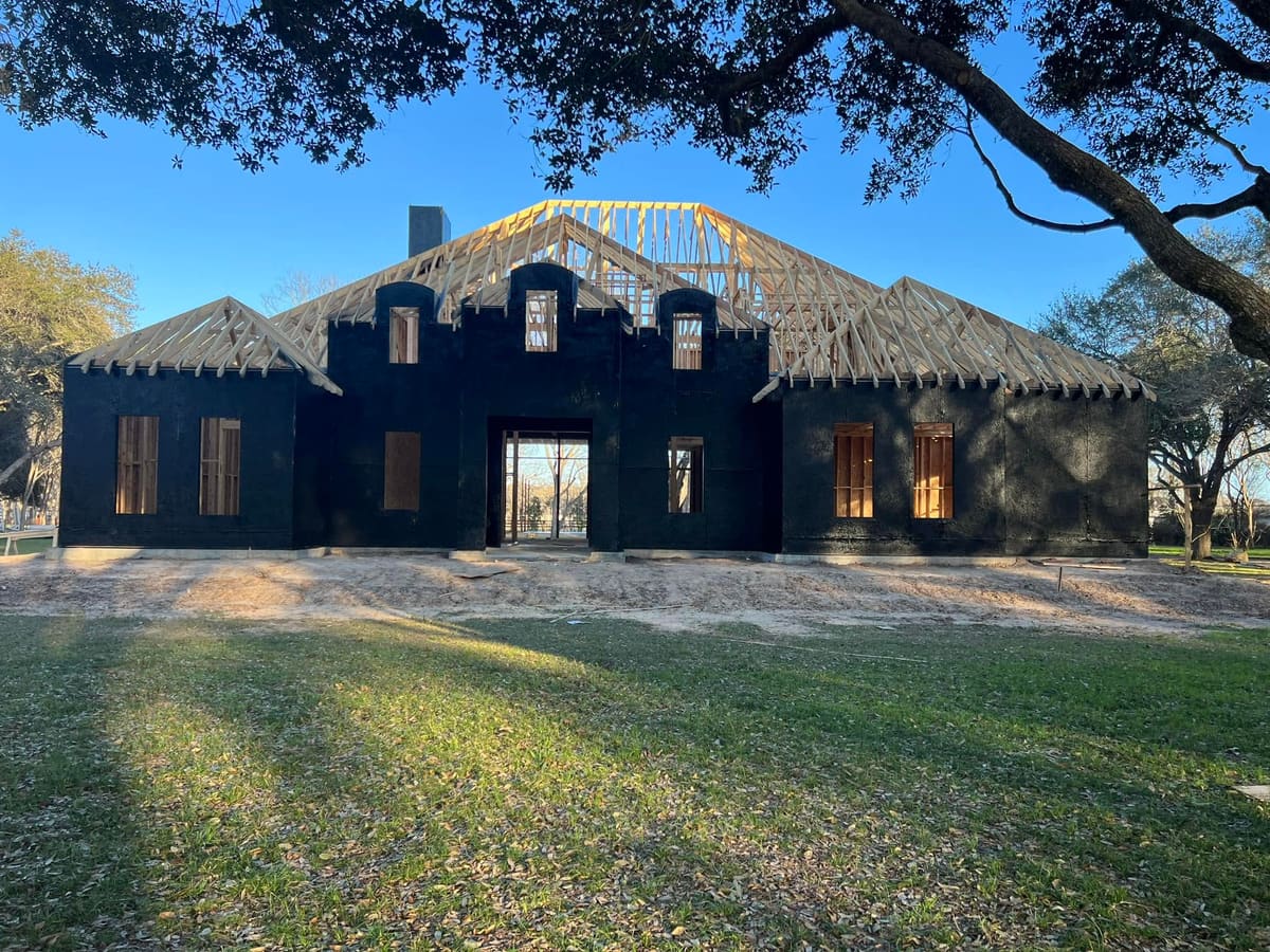 New home dried in with black weather barrier and roof trusses set