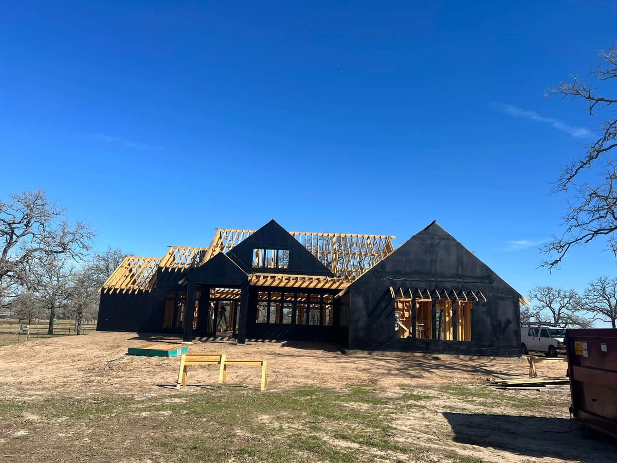 New custom home framed and wrapped on a large wooded lot