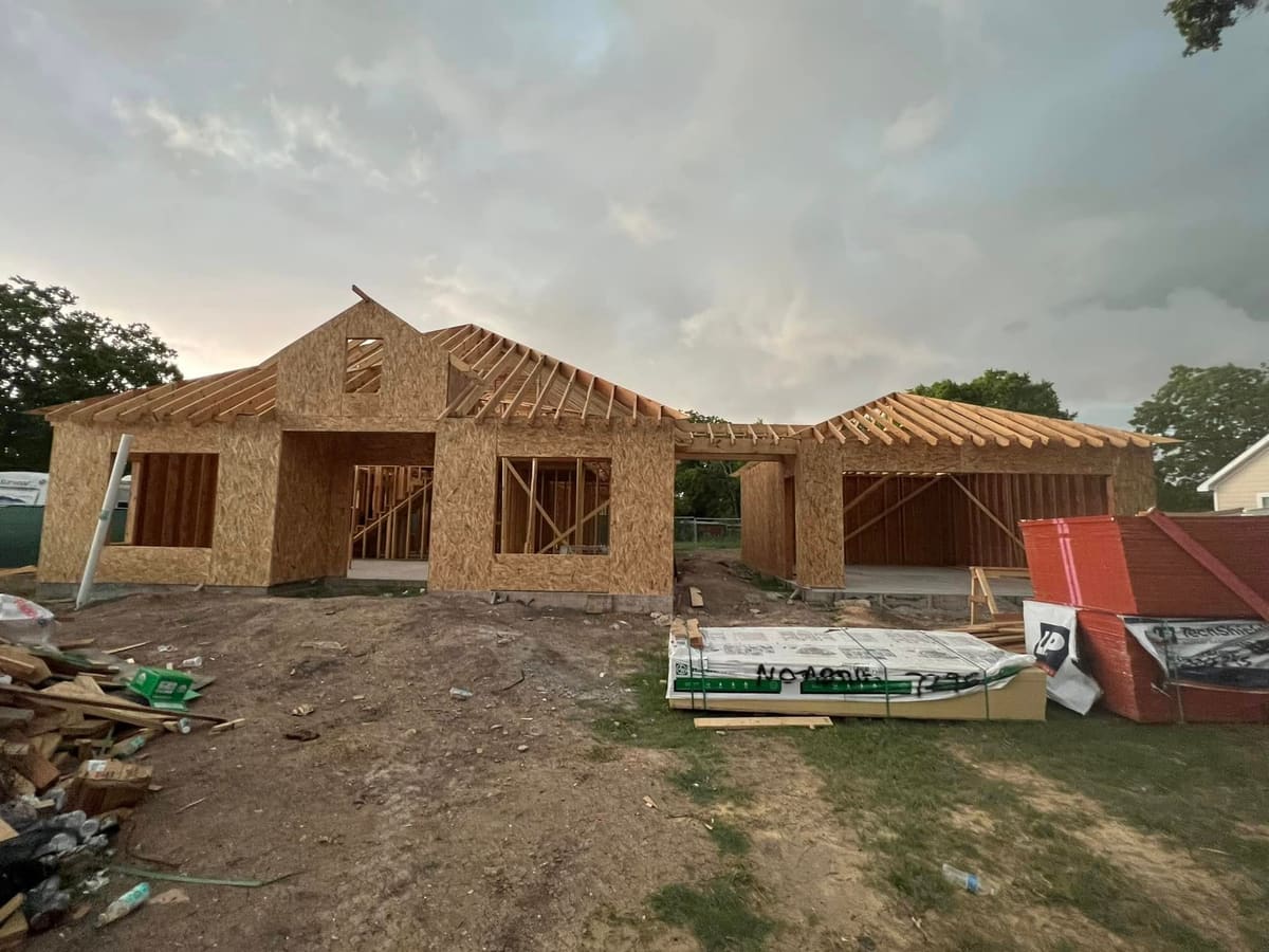 New single-story home framed and sheathed, with roof trusses set