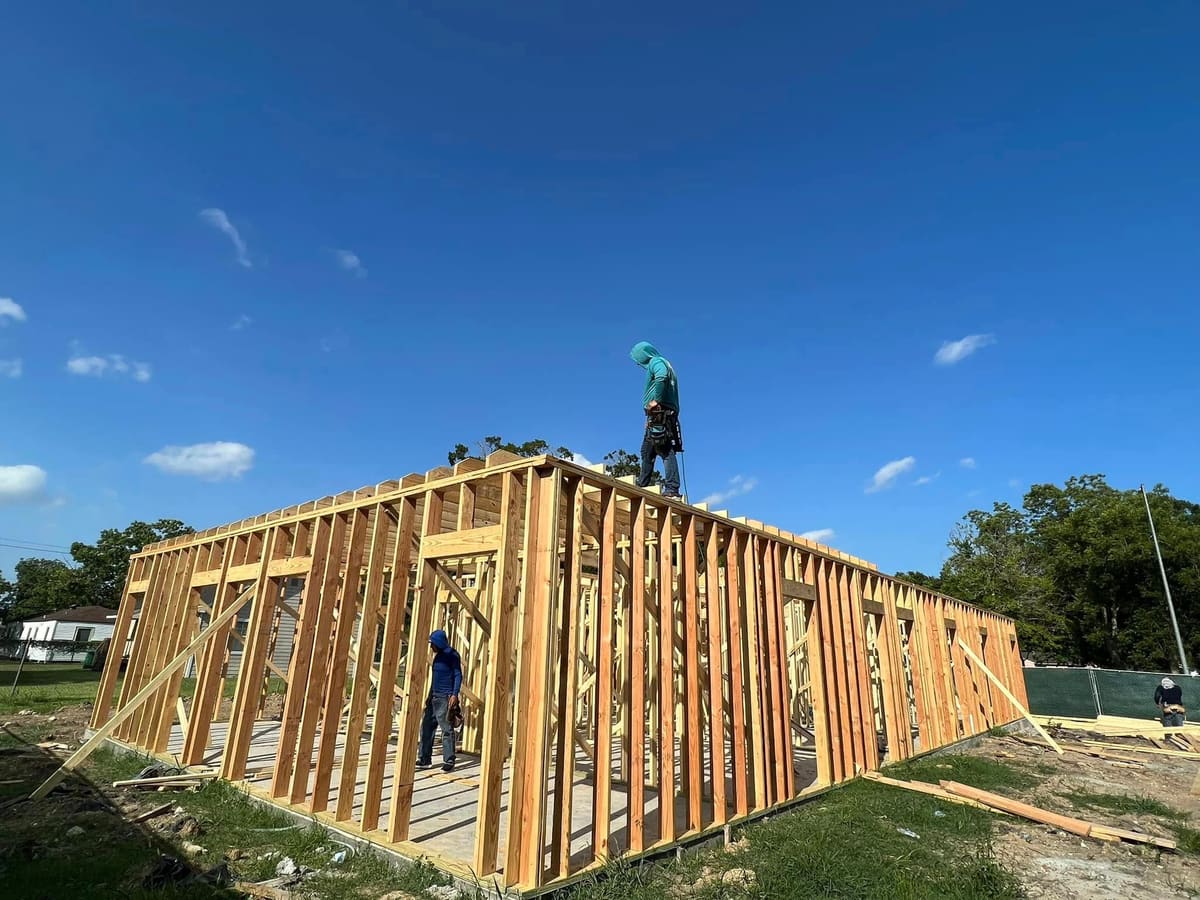 Carpenter on top of newly framed exterior walls
