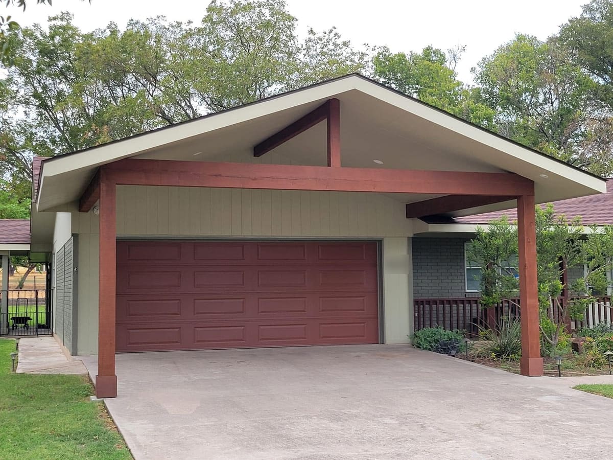 Two-car garage with a new gable roof extension on timber posts