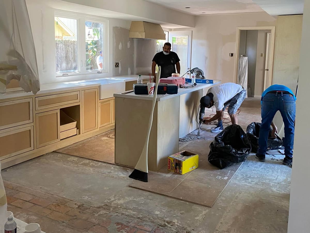 Kitchen remodel in progress with the crew setting the island