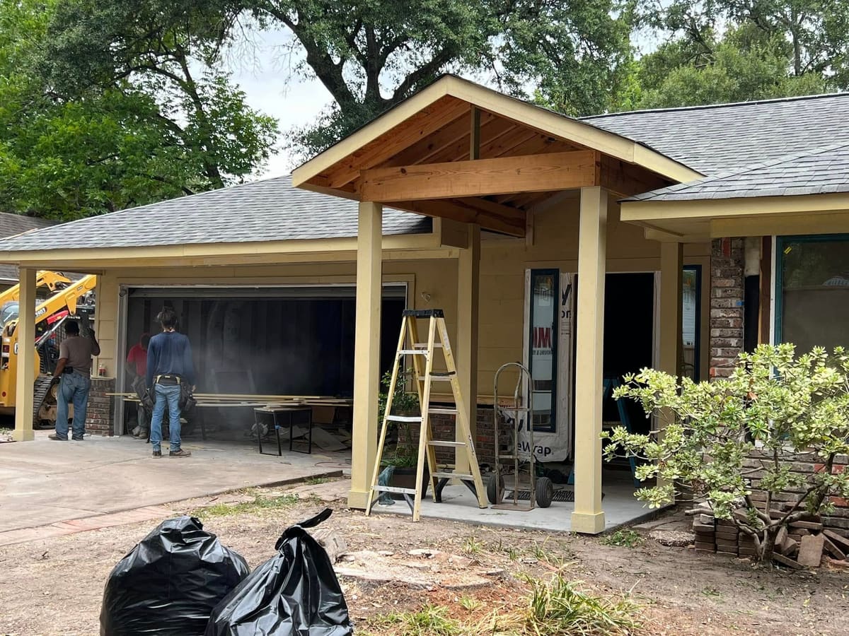Gable porch addition being built over a front entry