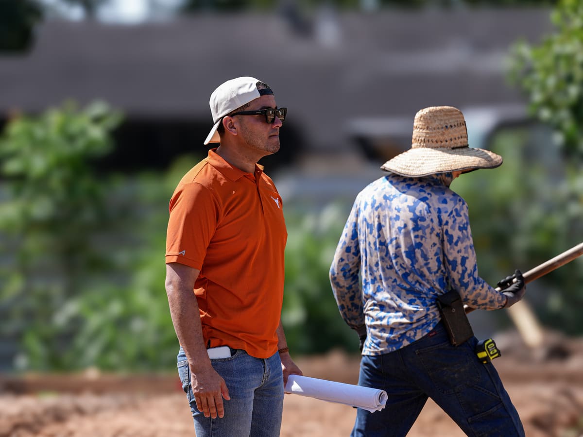 Project lead and crew member checking trench work on a new home site